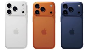 Three iPhone 17e models in Black, White, and Brown standing side-by-side showing the front notch and single rear camera