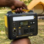 A man holding one of the best portable power station for camping